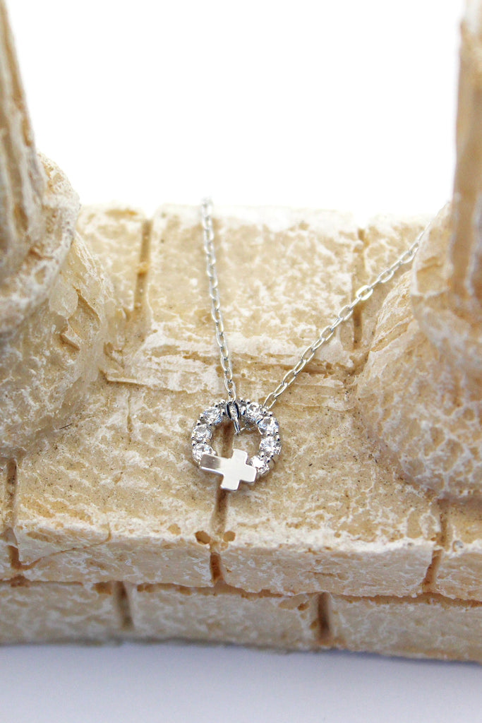 Crystal circle mini cross necklace