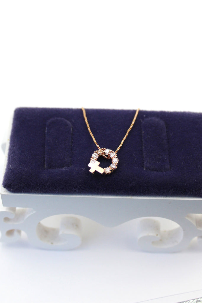 Crystal circle mini cross necklace