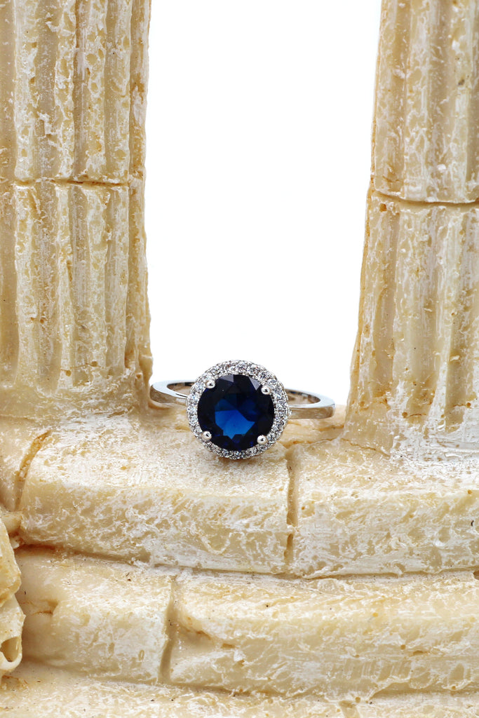 A layer micro-inlaid surrounded blue crystal silver ring
